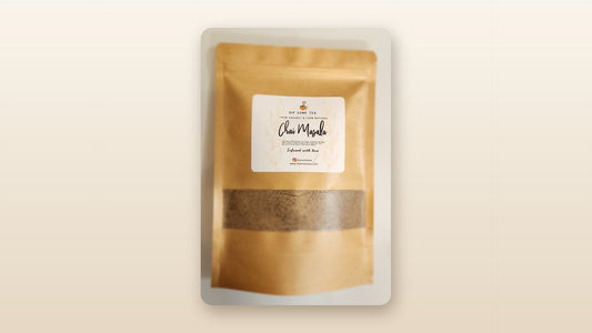 DipSomeTea pure and organic chai masala kraft pouch with ground spices visible through the window, framed on a soft cream background